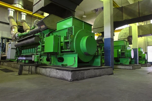 A green machine in an industrial setting.