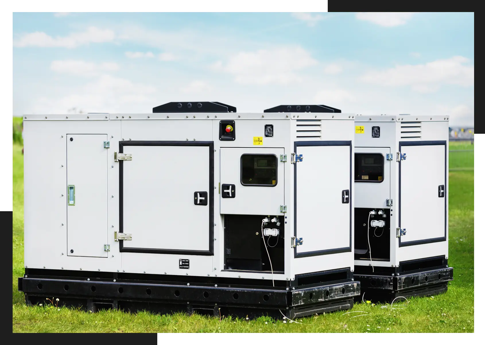 A group of generators sitting in the grass.