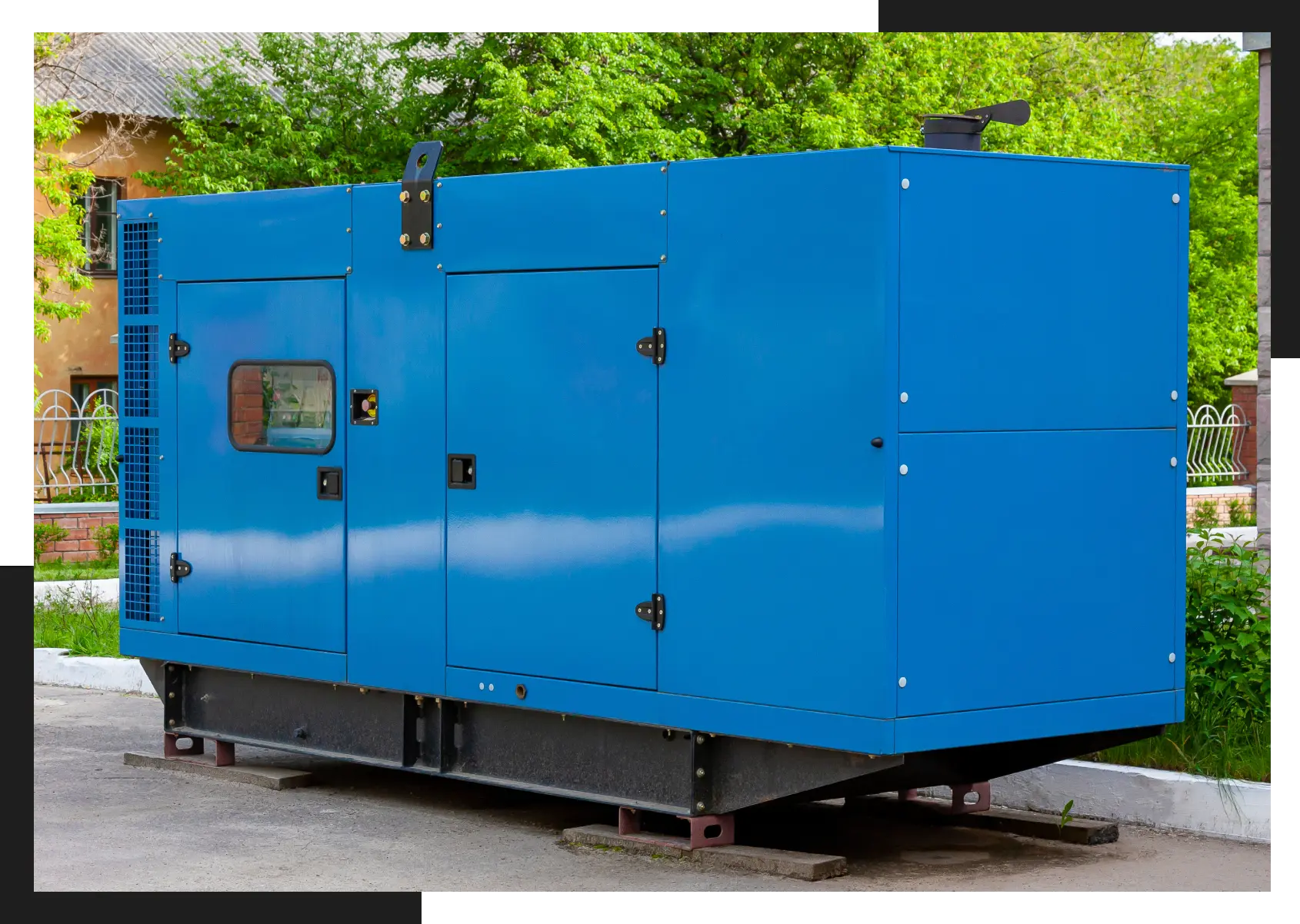 A blue generator sitting on top of concrete.